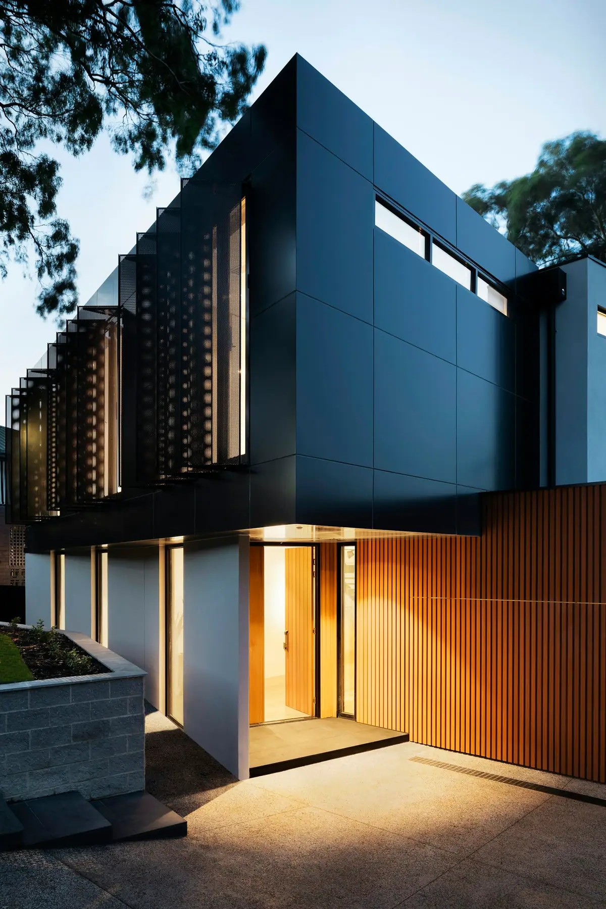 A modern house with deep eaves and warm stone